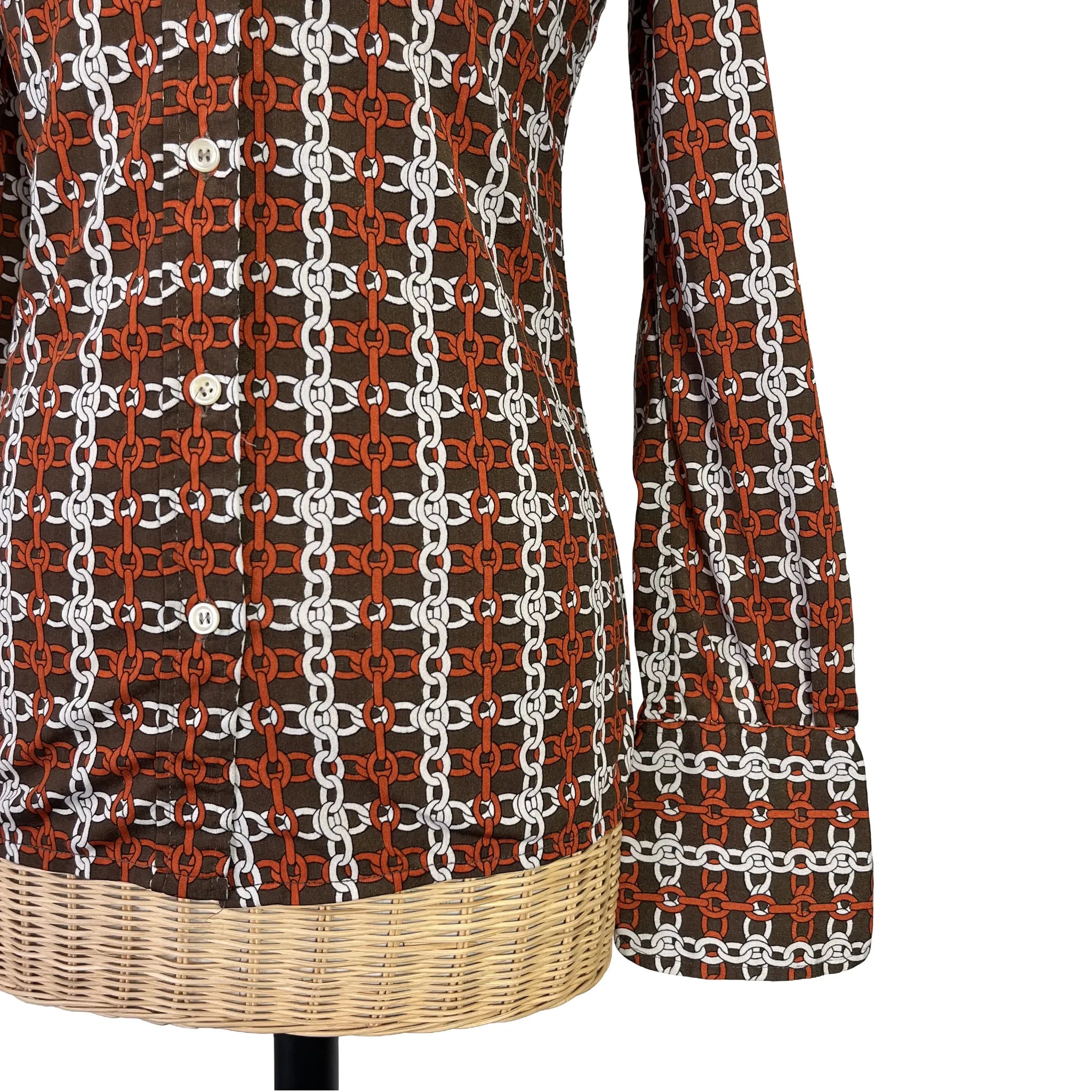 Détail bas de manche et bas du vêtement du chemisier femme Nina Ricci marron à motifs, taille 36