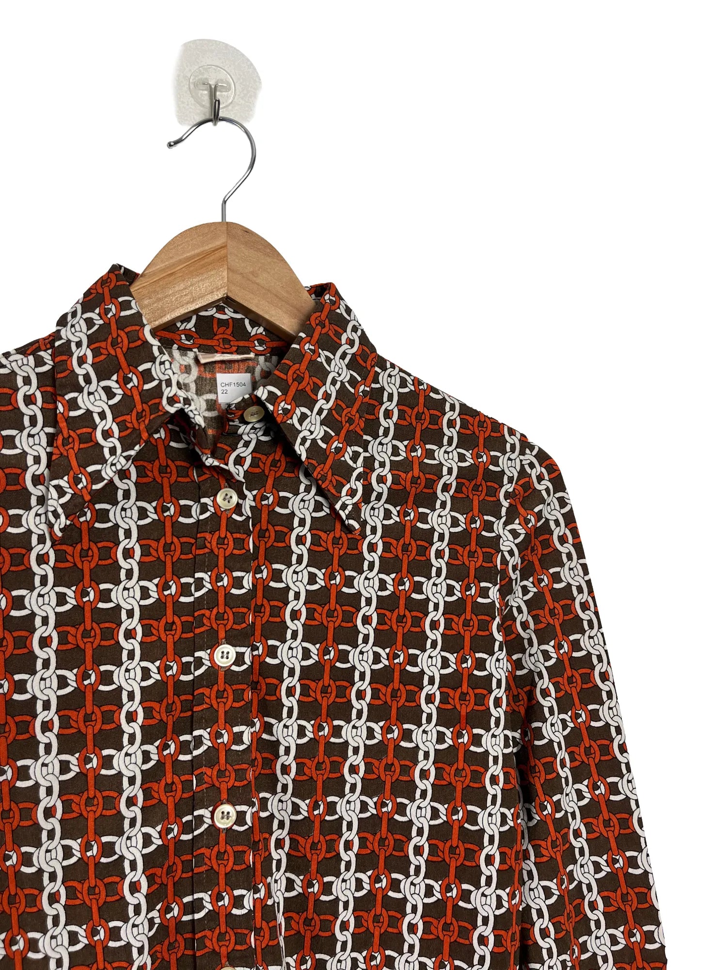 Détail motifs blancs et orange du chemisier femme Nina Ricci marron taille 36